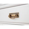 Blízky pohľad na šuflík s madlom v starozlatej farbe, ktorý je súčasťou bielej komody Toskania z dreva, pohľad zboku.